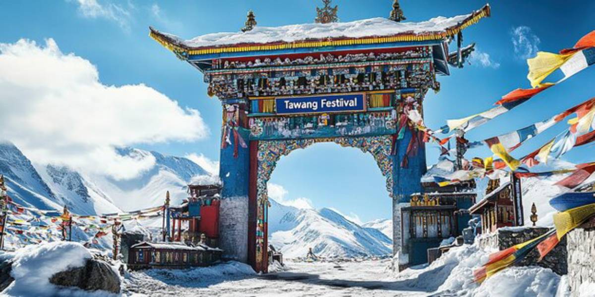 Colorful archway marking the Tawang Festival, surrounded by snow-covered mountains and vibrant prayer flags under a clear blue sky.